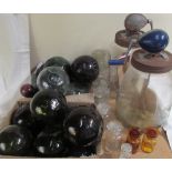 A collection of glass fishing floats together with glass regent bottles and two "Blow" butter