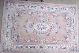A cream ground Chinese rug together with two other Chinese rugs