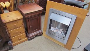 A pebble effect electric fire together with a hardwood bedside cabinet and a pine chest of drawers