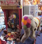 A puppet show together with assorted dolls furniture and a push along elephant