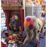 A puppet show together with assorted dolls furniture and a push along elephant