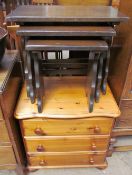 A pine chest of drawers together with an oak nest of tables