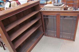 An oak bookcase with a rectangular top above three shelves on a plinth base,