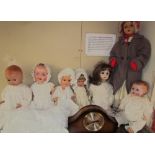 An Armand Marseille composition head doll together with a collection of dolls and a mantle clock