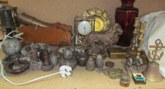 A Kundo anniversary clock together with a brass dish, brass lion, brass candlesticks,