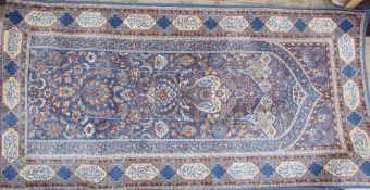 A blue ground rug together with another rug