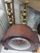 A large pair of brass candlesticks together with a mantle clock