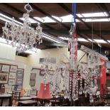 A pair of glass eight branch lustre drop chandeliers