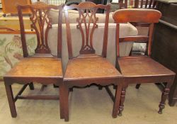 A pair of George III oak dining chairs with an interlaced vase splat above a solid seat on square