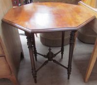 A Victorian walnut occasional table with an octagonal top on four turned legs united by an X