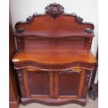 A Victorian mahogany chiffonier, with a carved cresting and shelf,