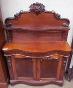 A Victorian mahogany chiffonier, with a carved cresting and shelf,