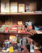 An AgiFlash camera together with other cameras, cigarette cards, mags lantern slides,