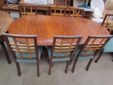 A reproduction mahogany extending dining table together with seven chairs and a sideboard and a