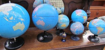 A miniature gem set globe together with six other globes