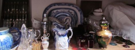 Assorted drinking glasses together with a part dinner set, blue and white plates,