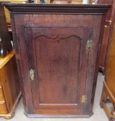 An 18th century oak hanging corner cupboard,