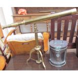 A reproduction brass telescope on a tripod base together with a copper Stern lamp (converted to