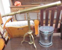 A reproduction brass telescope on a tripod base together with a copper Stern lamp (converted to