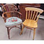 A yew Windsor chair with a hooped stick back with central vase splat above a solid seat on turned