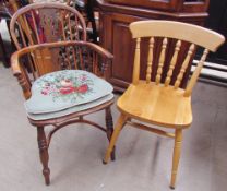 A yew Windsor chair with a hooped stick back with central vase splat above a solid seat on turned