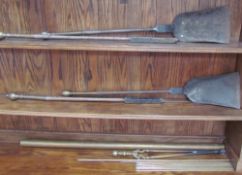 19th century brass and cast iron fire irons including two shovels and two pokers,