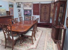 A reproduction mahogany dining suite comprising an extending dining table,