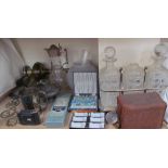 A three decanter tantalus together with a box brownie camera, brass oil lamp, cased spoons,