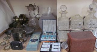 A three decanter tantalus together with a box brownie camera, brass oil lamp, cased spoons,