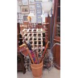 A pair of wine racks together with an umbrella stand, walking sticks, shooting sticks,