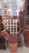 A pair of wine racks together with an umbrella stand, walking sticks, shooting sticks,