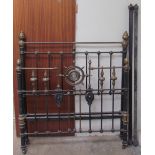 A 19th century brass and iron double bed, with turned finials and ribbed roundels, 140cm wide,