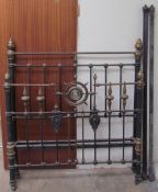 A 19th century brass and iron double bed, with turned finials and ribbed roundels, 140cm wide,