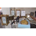Three French brass carriage clocks together with a miniature carriage clock,