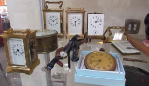 Three French brass carriage clocks together with a miniature carriage clock,