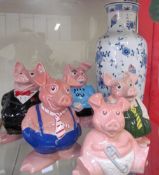 A set of five Wade NatWest pig piggy banks together with a continental porcelain vase