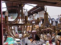 A pair of gilt metal eight branch chandeliers with matching wall lights