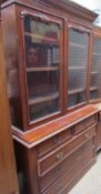 A Victorian mahogany married bookcase with a moulded cornice above a pair of glazed doors,