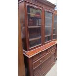 A Victorian mahogany married bookcase with a moulded cornice above a pair of glazed doors,