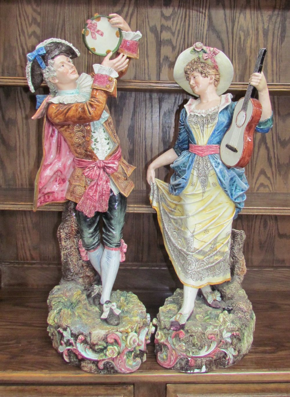 A large pair of continental pottery figures of musicians,