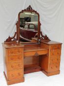 A Victorian mahogany dressing table, the central mirror with a pierced cresting rail,