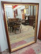 A large stained and gilt decorated wall mirror
