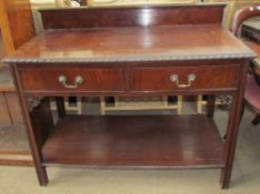 A Victorian mahogany side table with a raised back and a rectangular top with two drawers on square