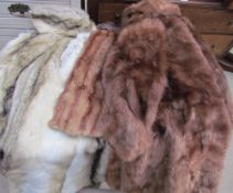 A collection of fur and faux fur coats