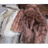 A collection of fur and faux fur coats