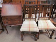 A reproduction mahogany bureau together with a set of four oak dining chairs