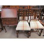 A reproduction mahogany bureau together with a set of four oak dining chairs