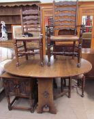 A 20th century oak gateleg dining table together with a set of four ladder back dining chairs and