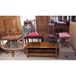 An oval teak coffee table with inset glass panel,