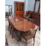 A Regency style mahogany extending dining table together with six chairs and a yew wall unit